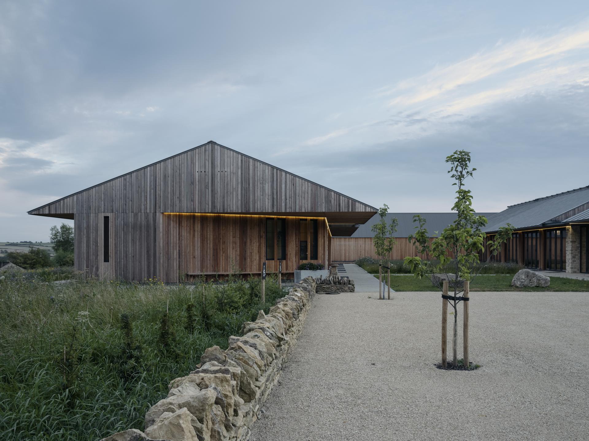 Sustainable farming education centre featuring modern wooden architecture and landscaped surroundings in the Cotswolds.