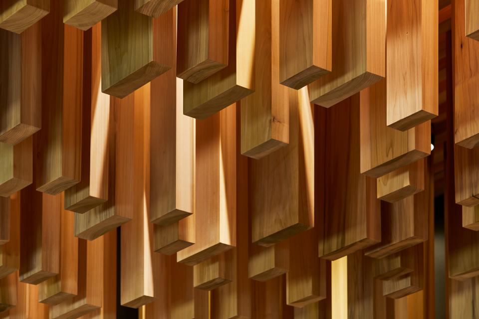 Intricately arranged American tulipwood blocks create a stunning visual display in the pavilion designed by David Adjaye.
