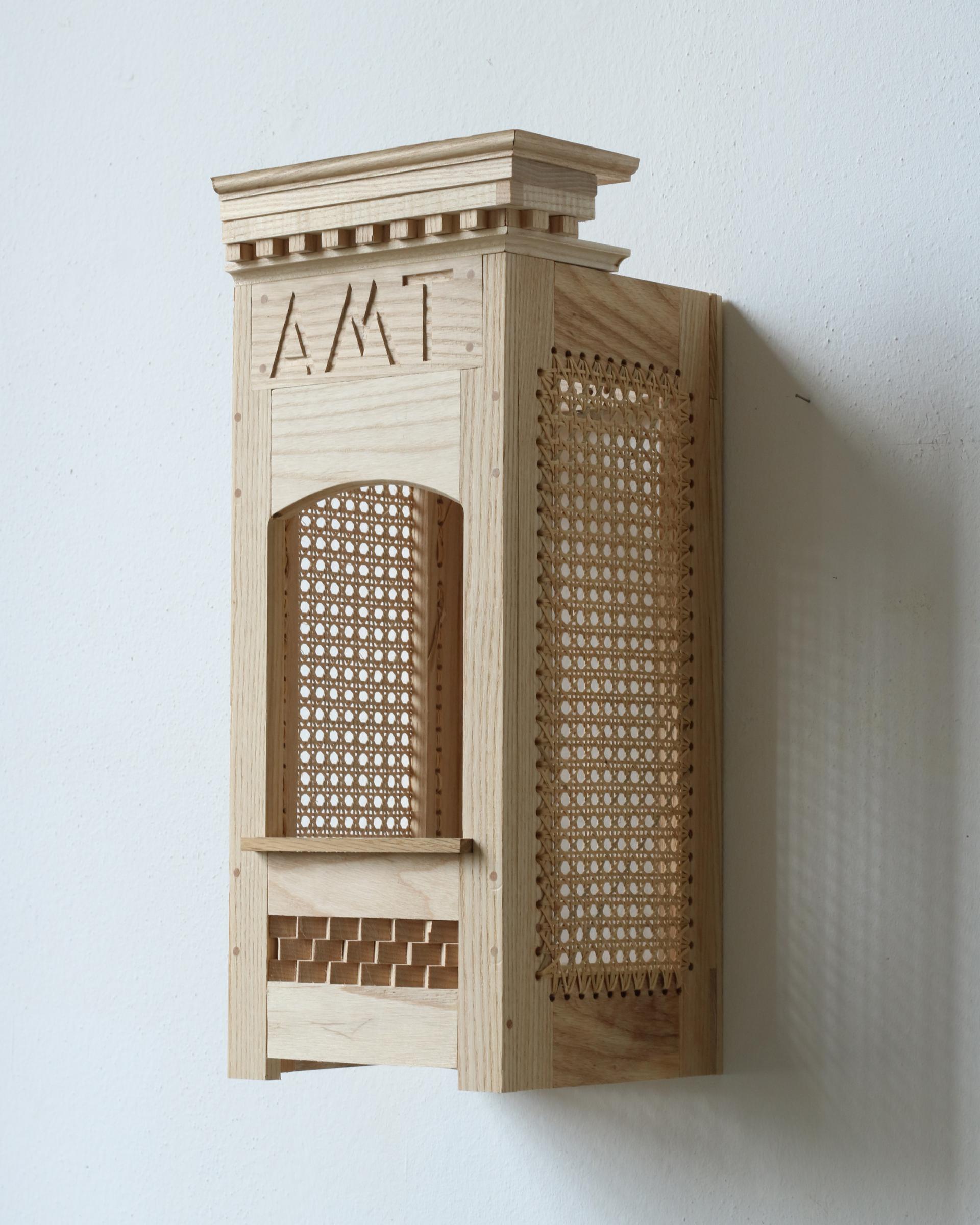 Intricate wooden model showcasing craftsmanship, featuring detailed cutouts and a unique architectural design by Charles Young.