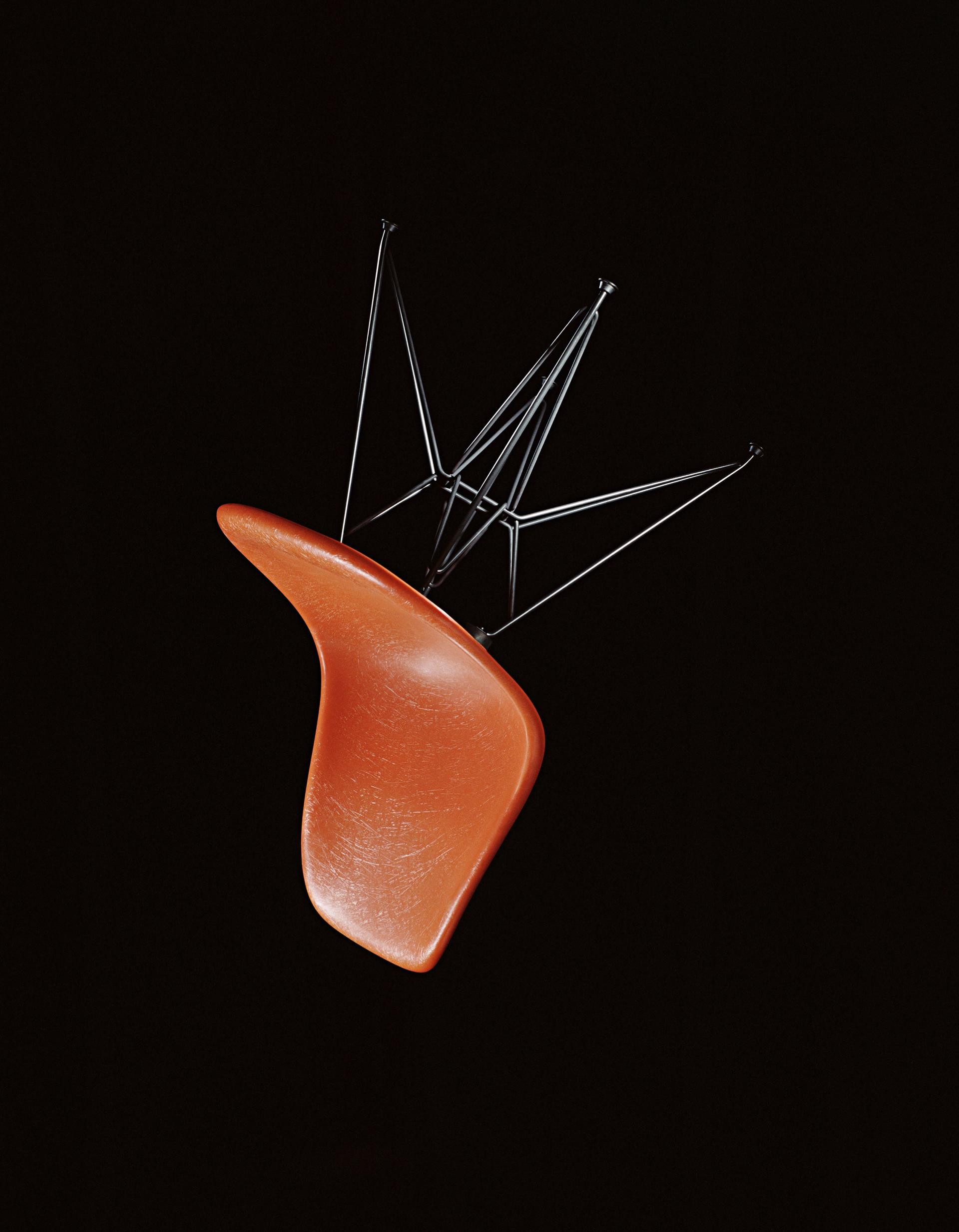 Modern orange chair by Vitra with a sleek wire base, showcased at the London Design Festival's exclusive edition collection.