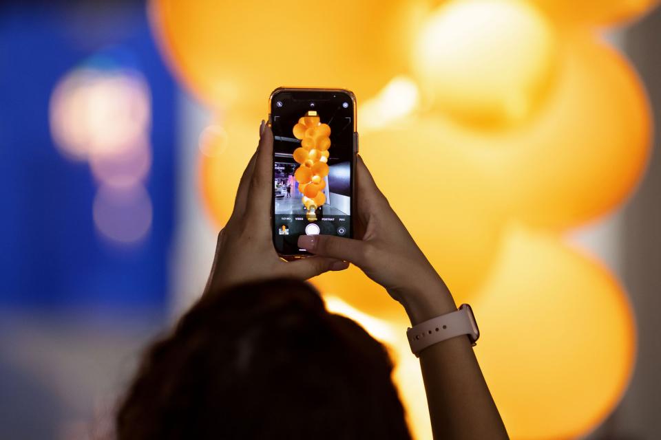 Capturing a vibrant display of the new Kuulas chandelier by Cameron Design House with glowing orange elements.