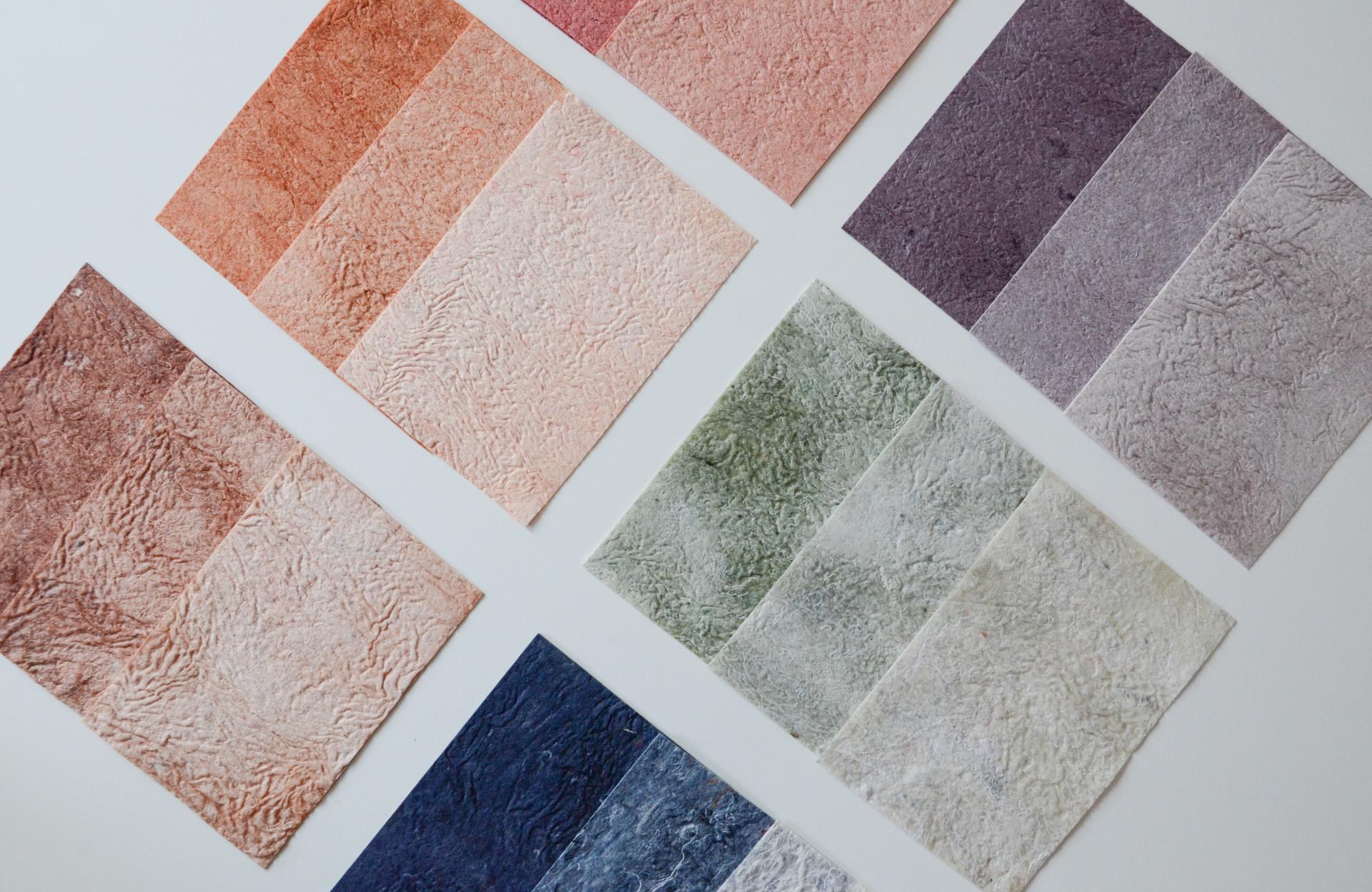 Colorful biomaterial samples displayed in textured sheets, showcasing sustainable design and innovative waste recycling by Studio Sarmite.