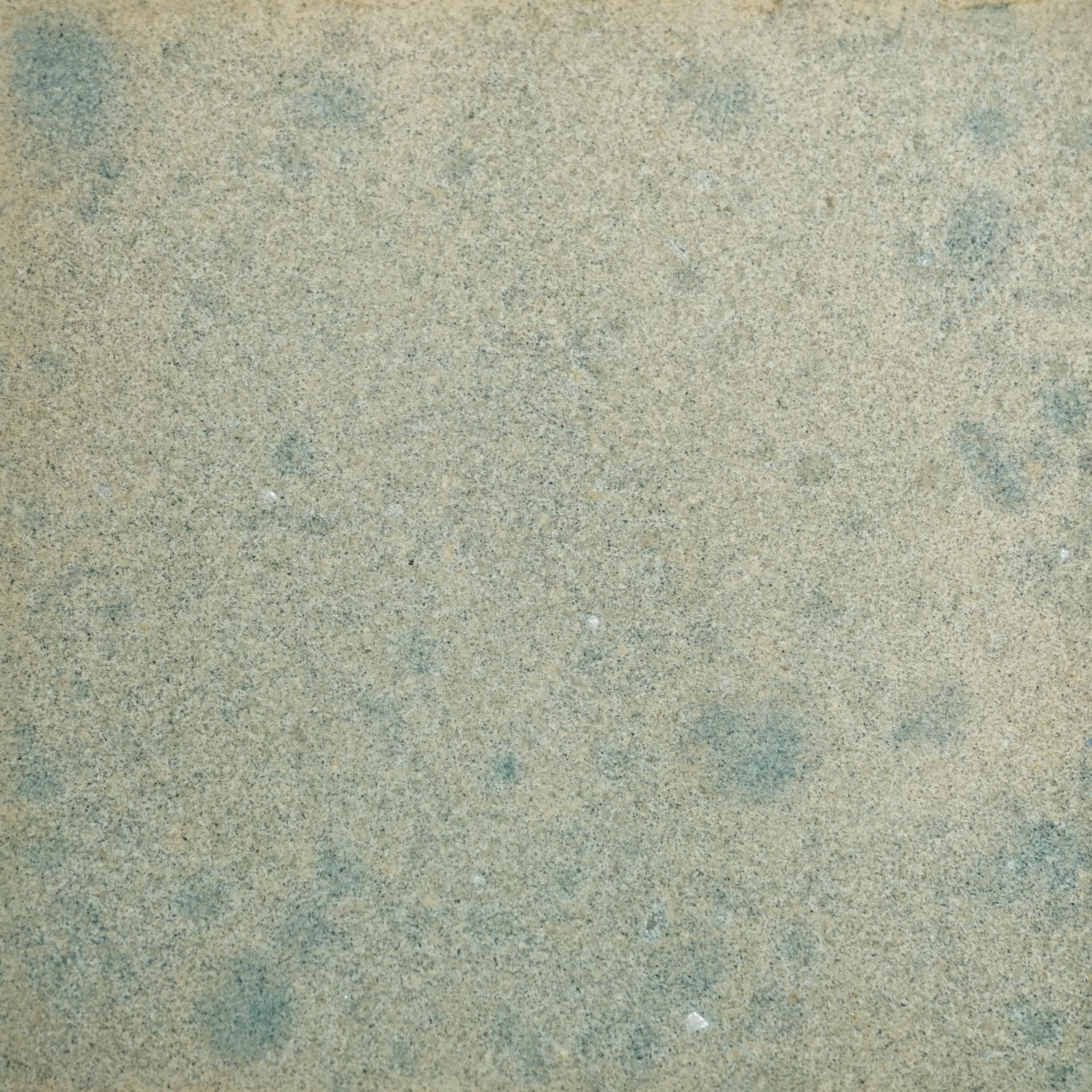 Textured surface featuring a blend of sandy and gray tones, representing materials used in DeakinBio's creative projects.