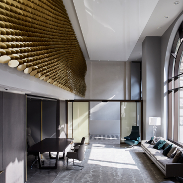 Interior view of The Veil, showcasing intricate brass louvres and modern design elements in an elegantly lit space.