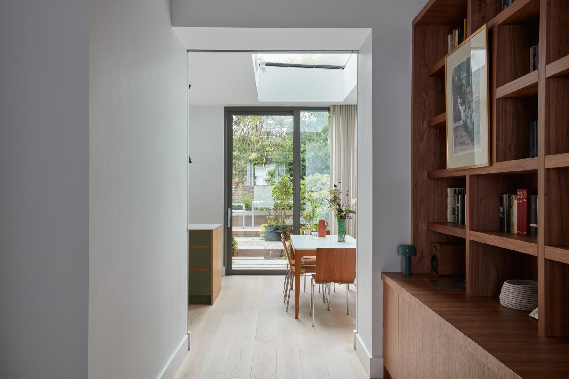 Modern interior view showcasing a spacious dining area with natural light and outdoor greenery at Woodsome Road.