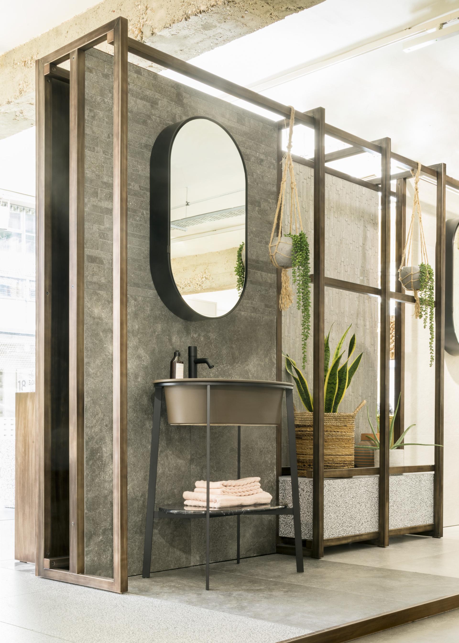 Modern bathroom display featuring a sleek basin, decorative plants, and a stylish mirror in Domus' Clerkenwell showroom.