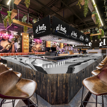 Modern bar interior of El Hefe Supermacho Taqueria featuring stylish seating and vibrant decor, perfect for Instagram.