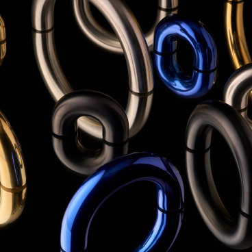 Modern architectural ironmongery pieces in various metallic finishes designed by Tom Dixon, showcasing innovative design elements.