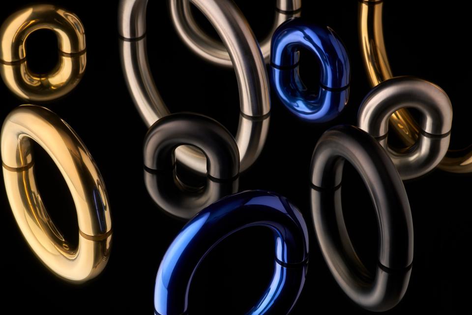 Modern architectural ironmongery pieces in various metallic finishes designed by Tom Dixon, showcasing innovative design elements.