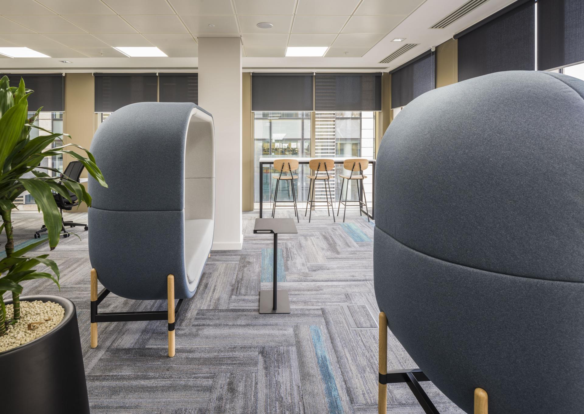 Modern office interior featuring innovative design elements, including stylish pod seating and an open workspace at Form Design Consultants.