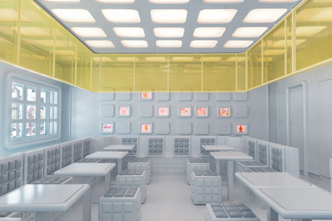 Bright, modern interior of the Novu Waffle, featuring futuristic design elements and playful yellow accents.