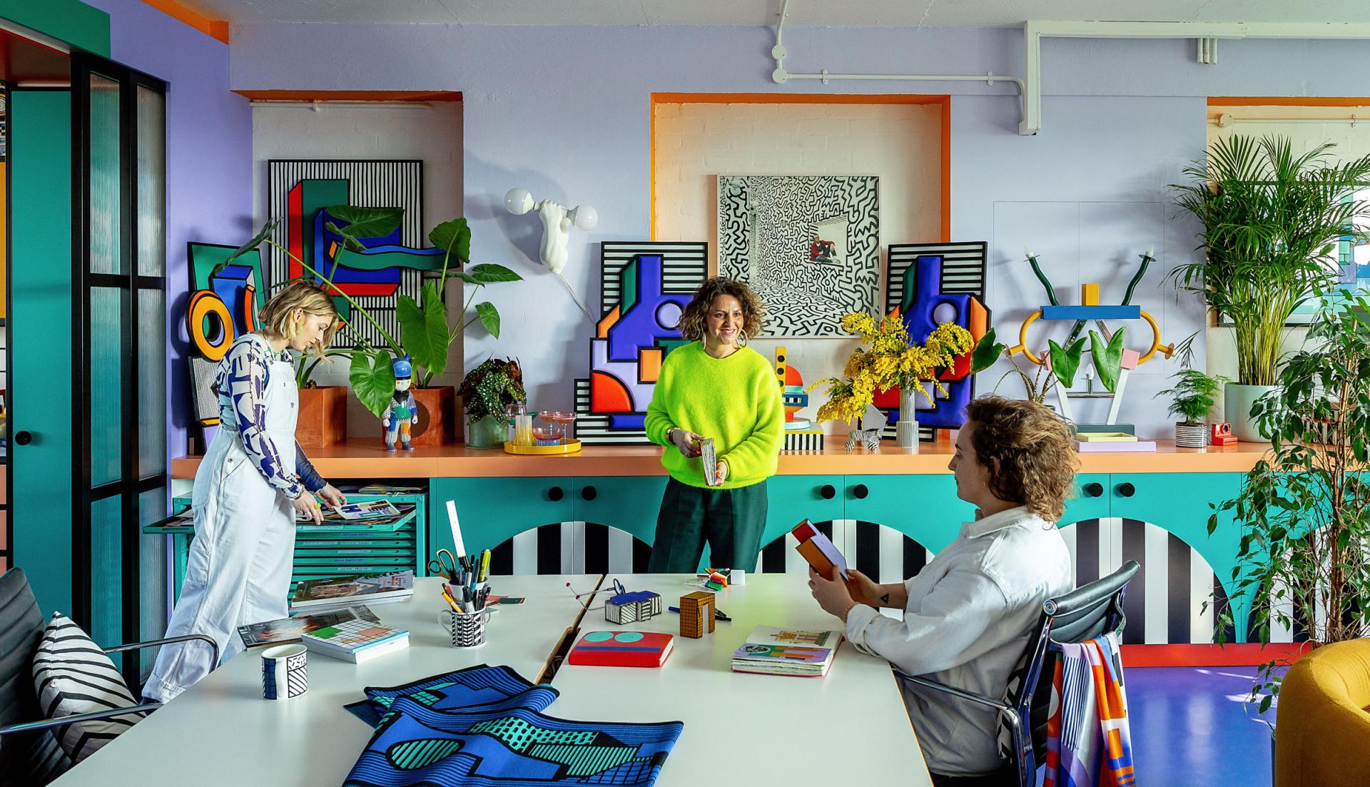 Brightly colored studio interior showcasing Camille Walala's signature style, featuring geometric art, vibrant decor, and creative workspace.
