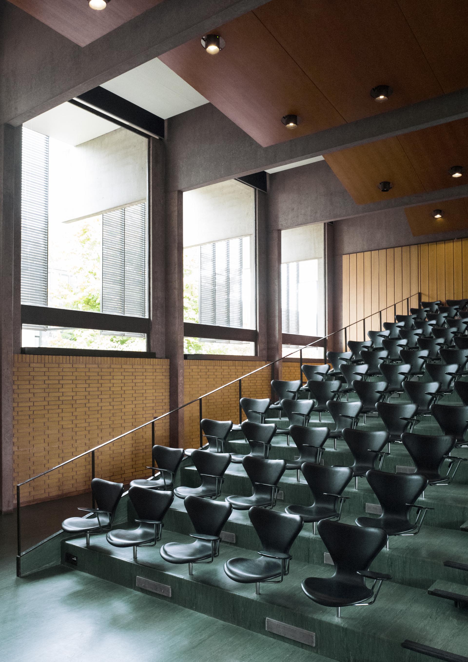 Modern auditorium seating at St Catherine’s College, University of Oxford, showcasing minimalist design and natural light.