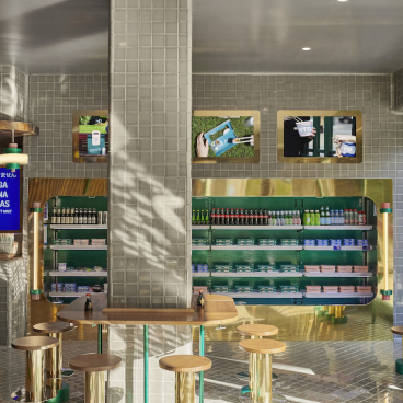 Modern sushi takeaway interior design featuring a vibrant color palette, sleek furniture, and organized product displays.