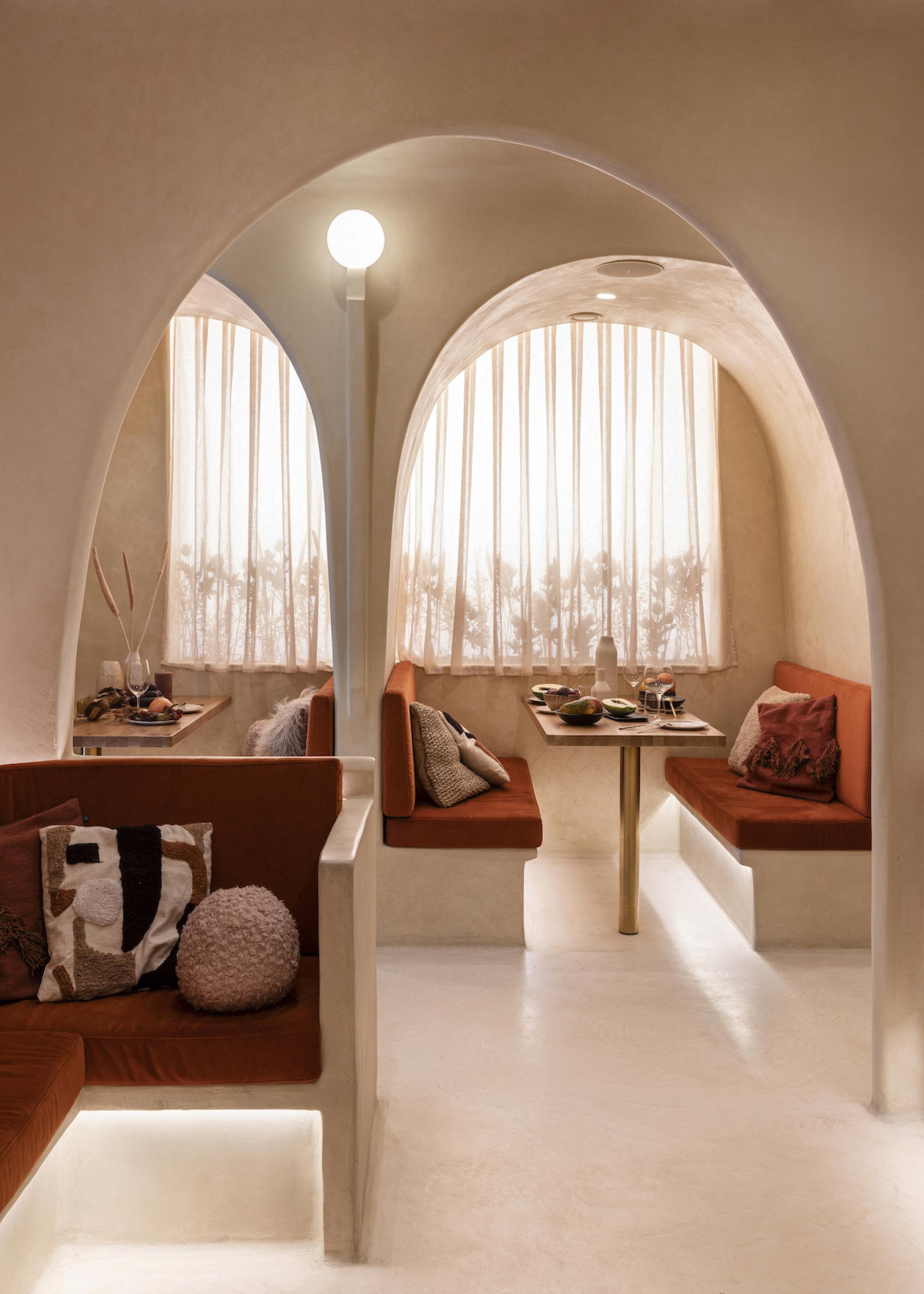 Elegant restaurant interior of Living Bakkali, showcasing Middle Eastern inspired design with cozy seating and natural light.