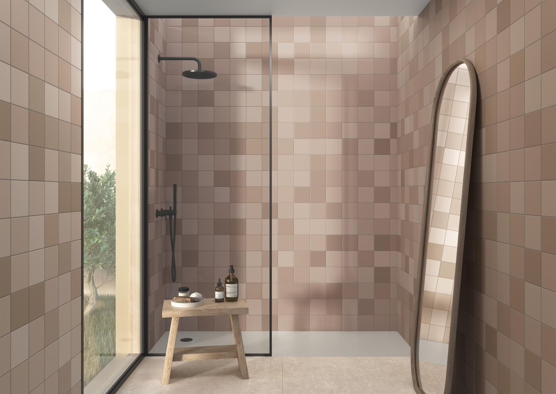 Modern bathroom featuring trendy ceramic tiles in earthy tones, a rain shower, and a sleek mirror.