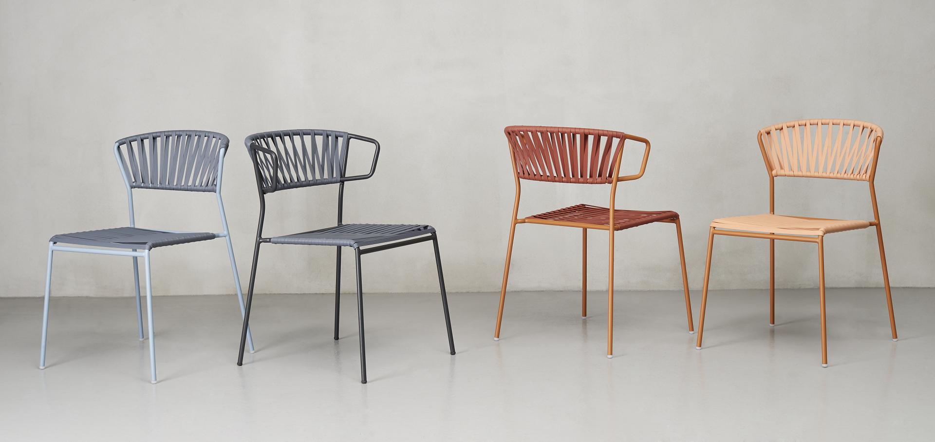 Four modern Lisa Club chairs in various colors, highlighting SCAB Design's innovative style and Red Dot Award-winning design.