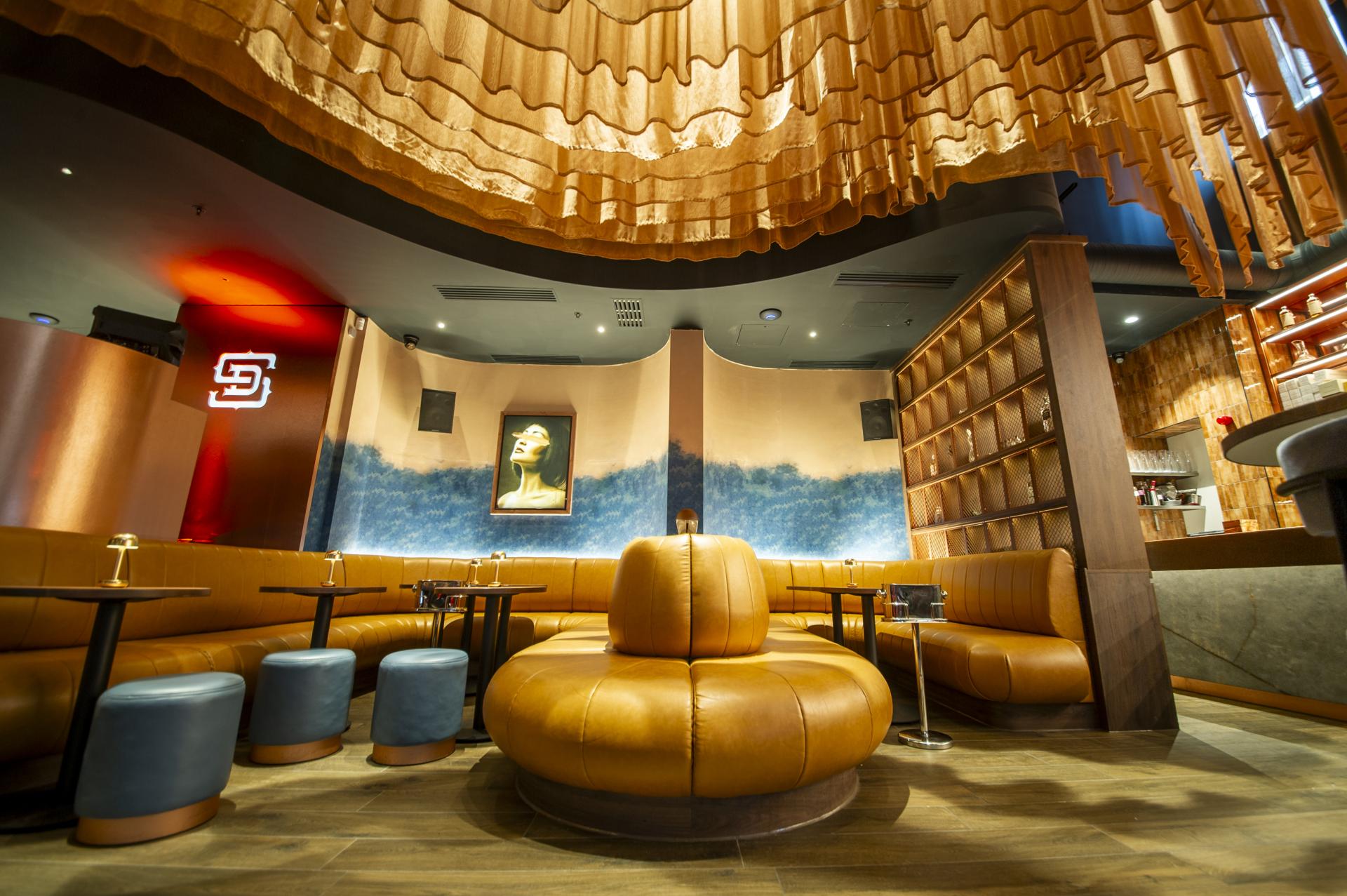 Stylish interior of AXI Studio's creative workspace featuring unique seating, art, and modern design elements.