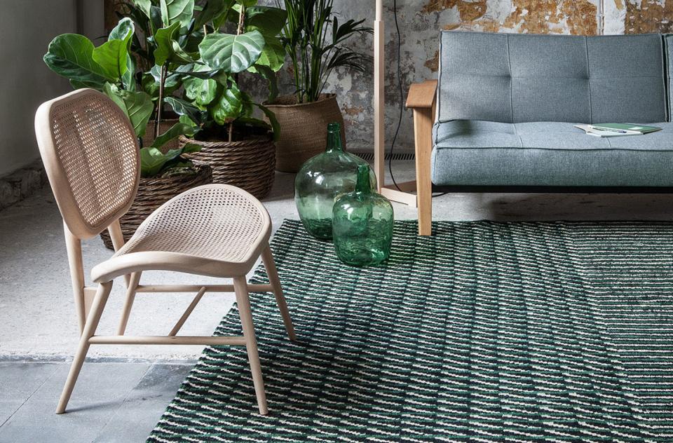 Stylish interior featuring Nanimarquina's Blur collection rug, Bouroullec-designed chair, and vibrant green decor elements.