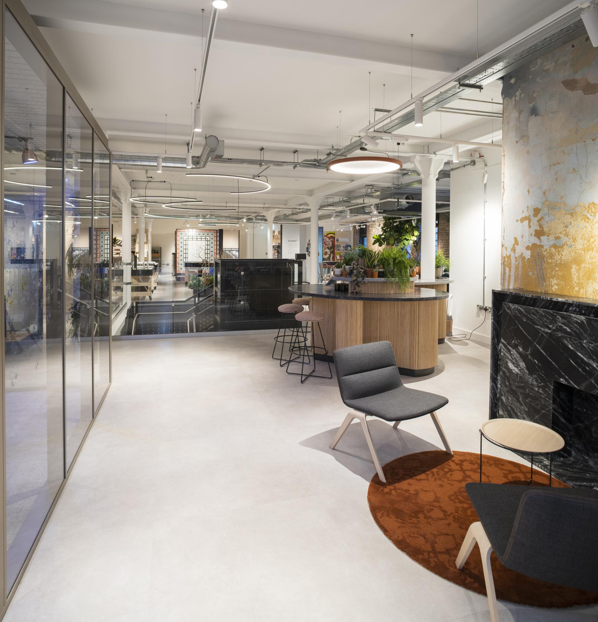 Spacious interior of Material Source Studio in Manchester, featuring modern furniture, greenery, and stylish design elements.