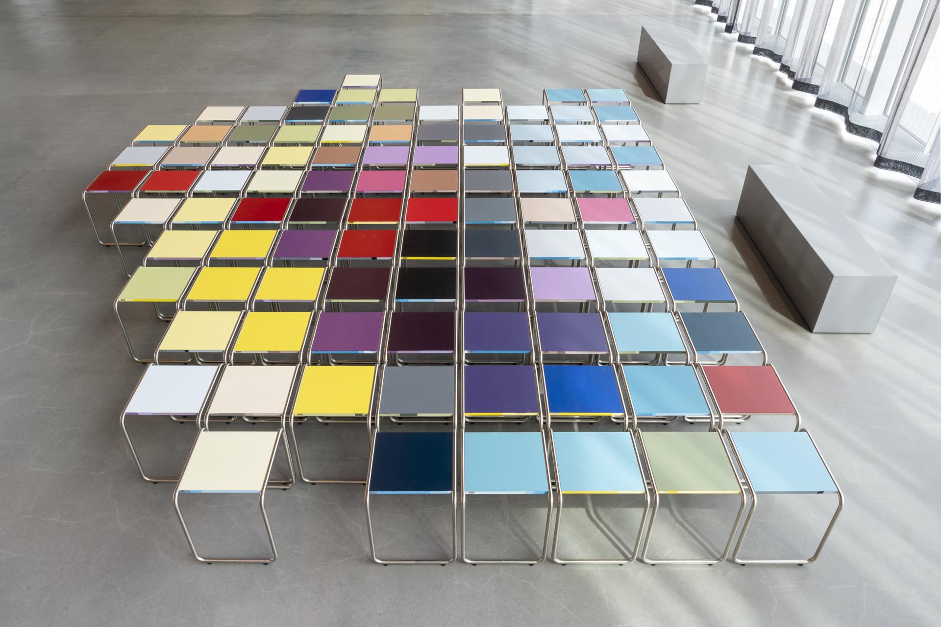 Colorful B 9 tubular steel stools arranged artistically in the Bauhaus Museum Dessau, showcasing modern design.