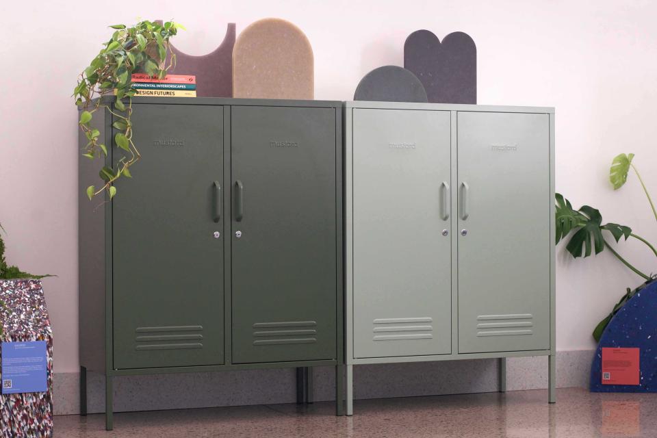 Midi lockers in sage and olive green, accented by decorative elements, brighten the Material Source Studio workspace.