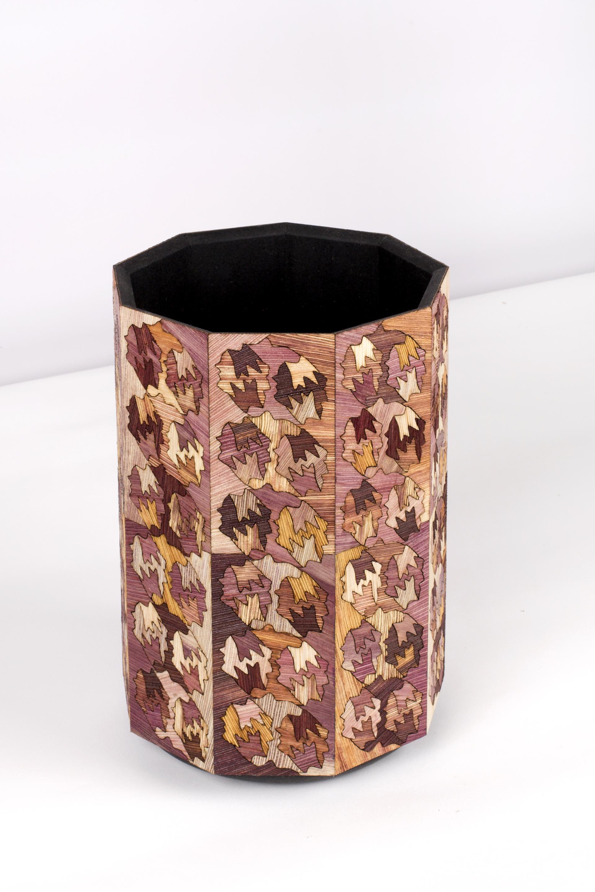 Colorful octagonal container made from Totomoxtle, showcasing intricate leaf patterns and sustainable design.
