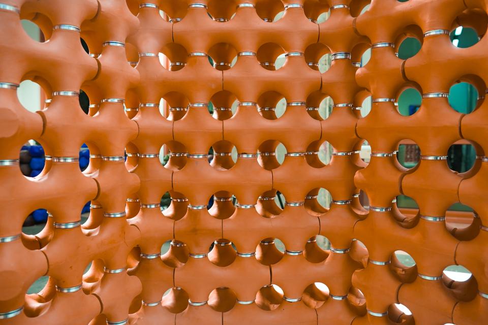 Innovative terracotta structure with circular holes, designed for natural cooling and urban temperature management by TerraCool.