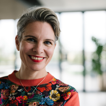 Shannon Conway, co-founder of Picture This, smiling in a bright, modern office space with plants in the background.