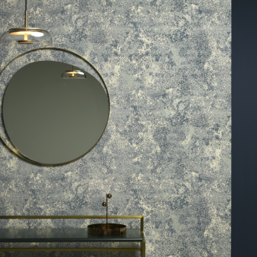 Elegant wall featuring Lelièvre Paris' new wallpaper design, complemented by modern decor elements including a round mirror and pendant light.