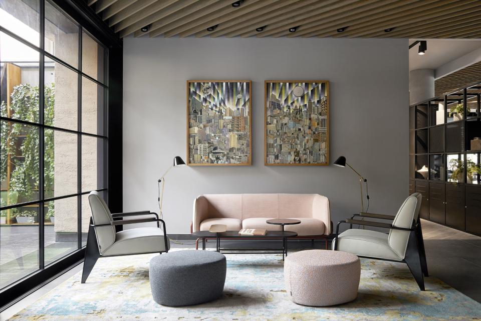 Stylish lounge area at PURO Kraków Kazimierz featuring modern furnishings and vibrant artwork, designed by Conran+Partners.