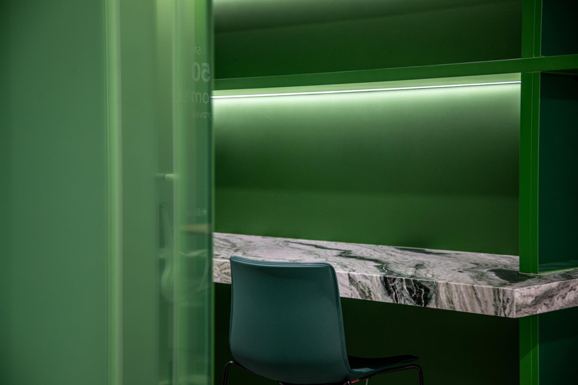 Modern workspace featuring a green environment, marble countertop, and a stylish chair, reflecting Dubai's vibrant culture.