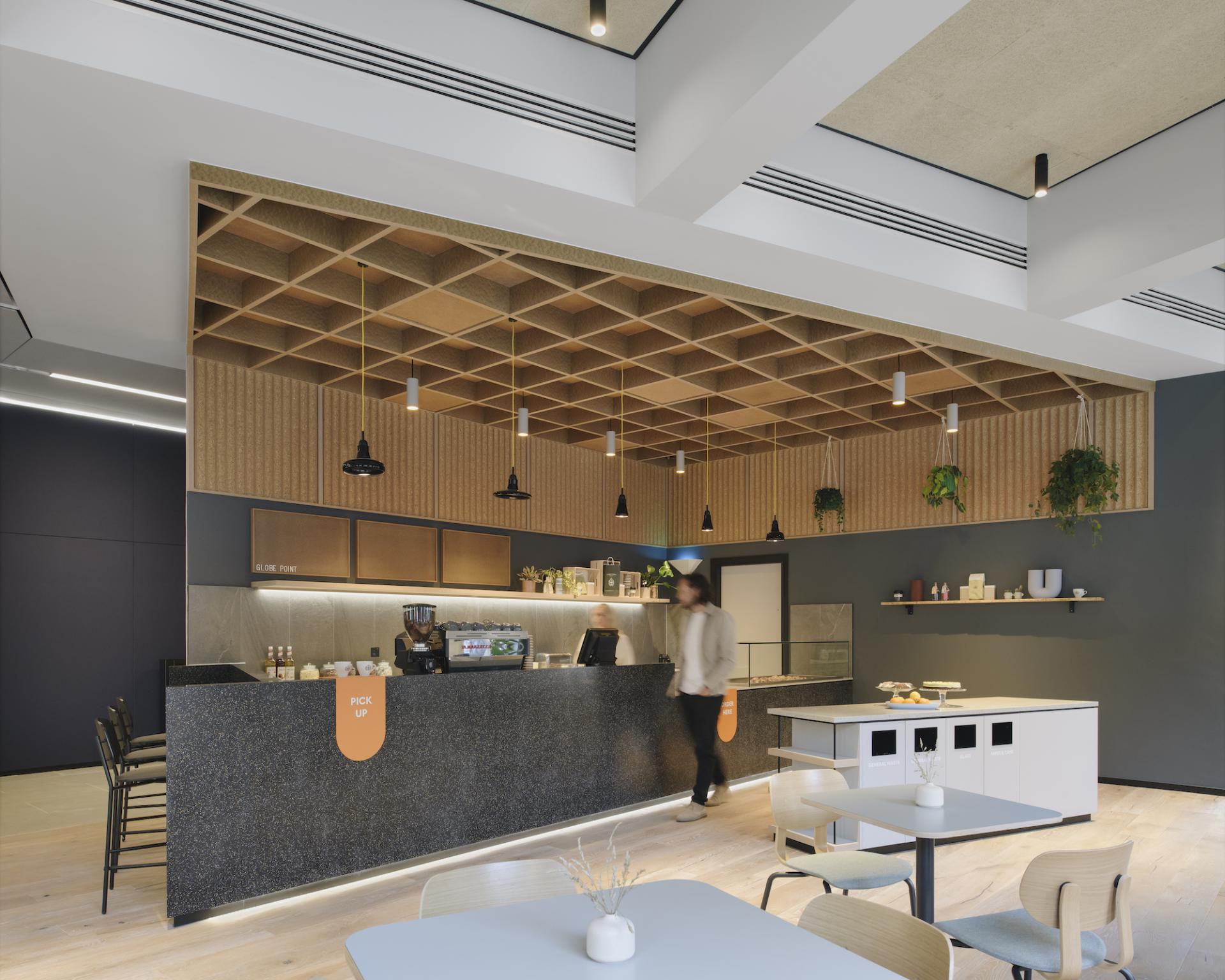 Contemporary cafe interior at Globe Point, featuring stylish countertops, seating, and modern lighting designed by Ekho Studio.