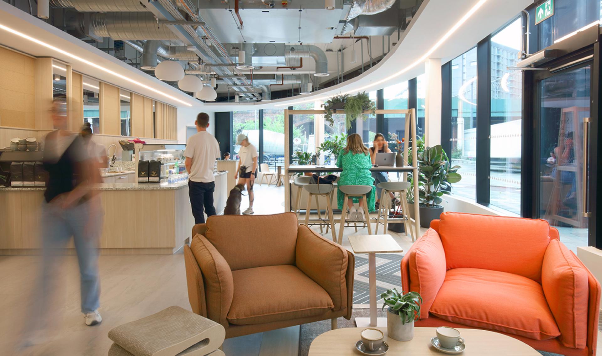 Modern social hub at Eden, New Bailey featuring cozy seating, a café counter, and community-friendly design elements.