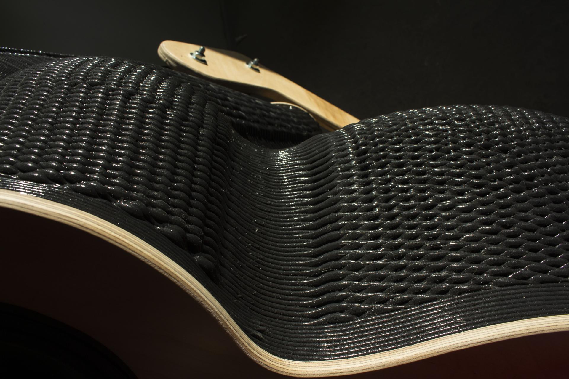 3D printed guitar body showcasing innovative wave patterns, highlighting advancements in sustainable materials for music instrument design.