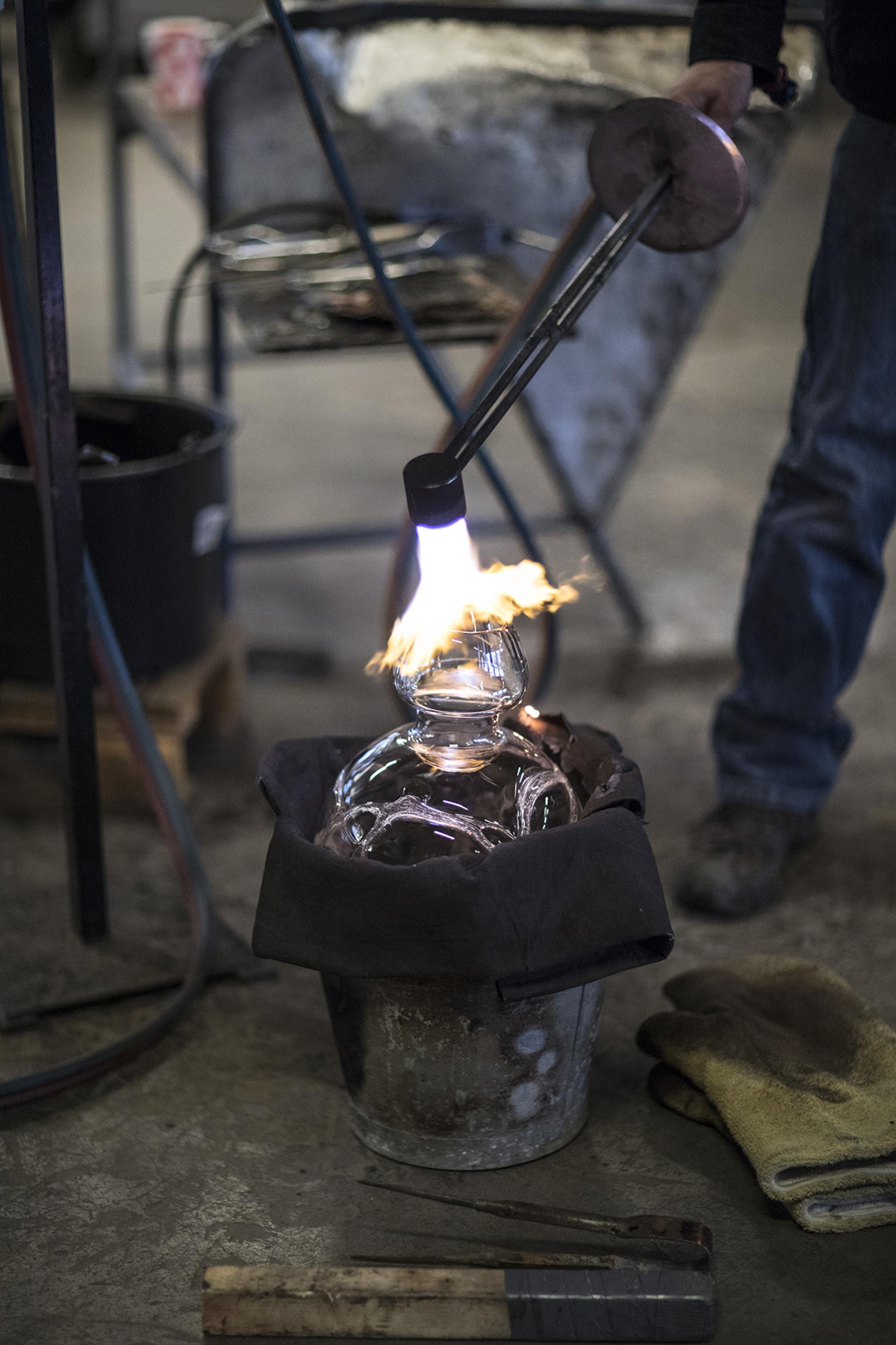 Artisan glassblowing at The Glass Factory in Småland, showcasing skilled techniques and artistic collaboration.