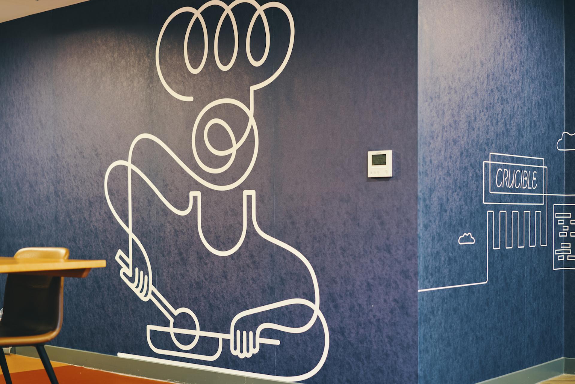 Stylish line art of a chef on a dark blue wall in Knight House, showcasing innovative interior design for student accommodation.