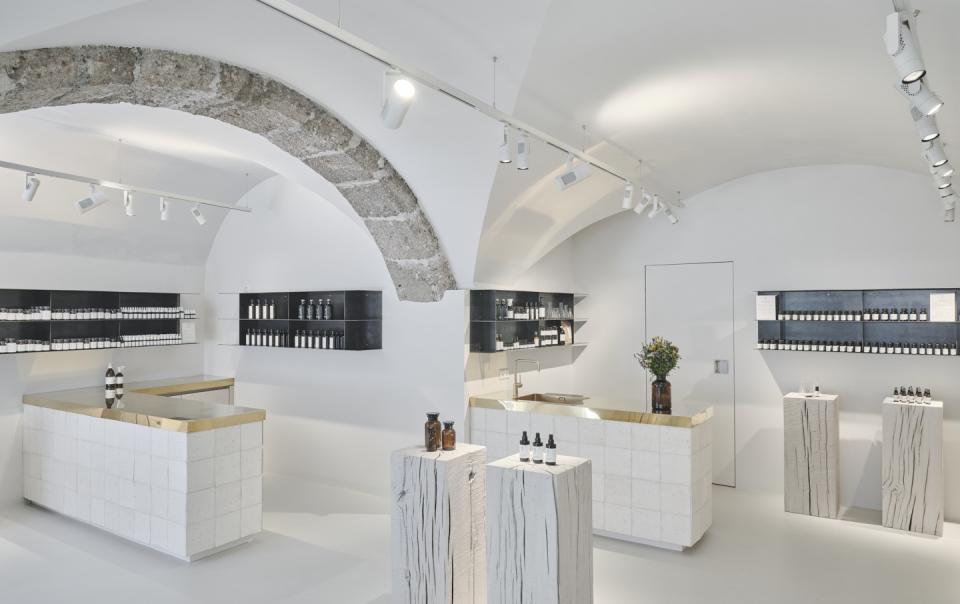 Modern interior of Saint Charles store in Salzburg, showcasing natural cosmetics on minimalist displays and natural materials.