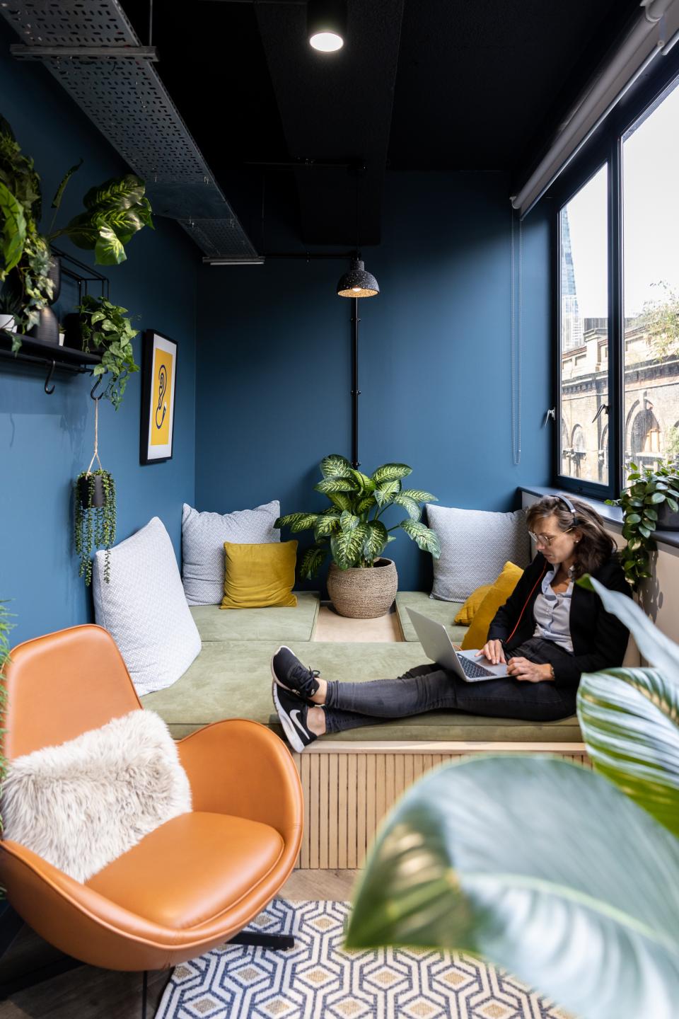 Cozy workspace featuring vibrant colors, patterned decor, and lush plants, ideal for productivity and creativity.