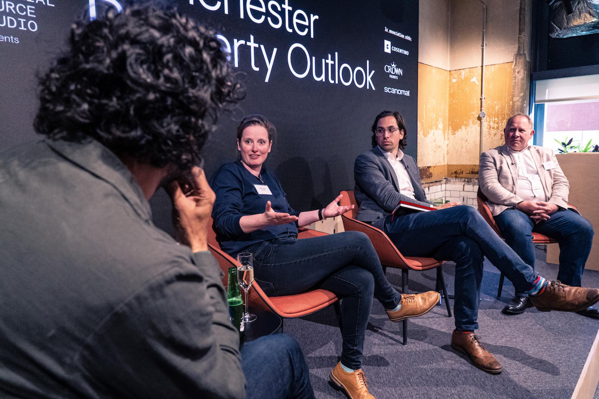 Discussion panel at the Manchester Property Outlook seminar featuring industry experts sharing insights on real estate trends.