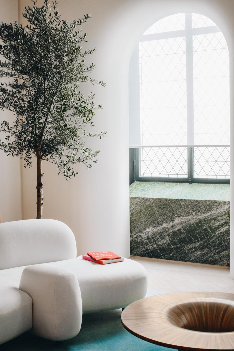 Modern interior featuring Mathieu Lehanneur's unique furniture design, including a sculptural sofa and artistic coffee table.