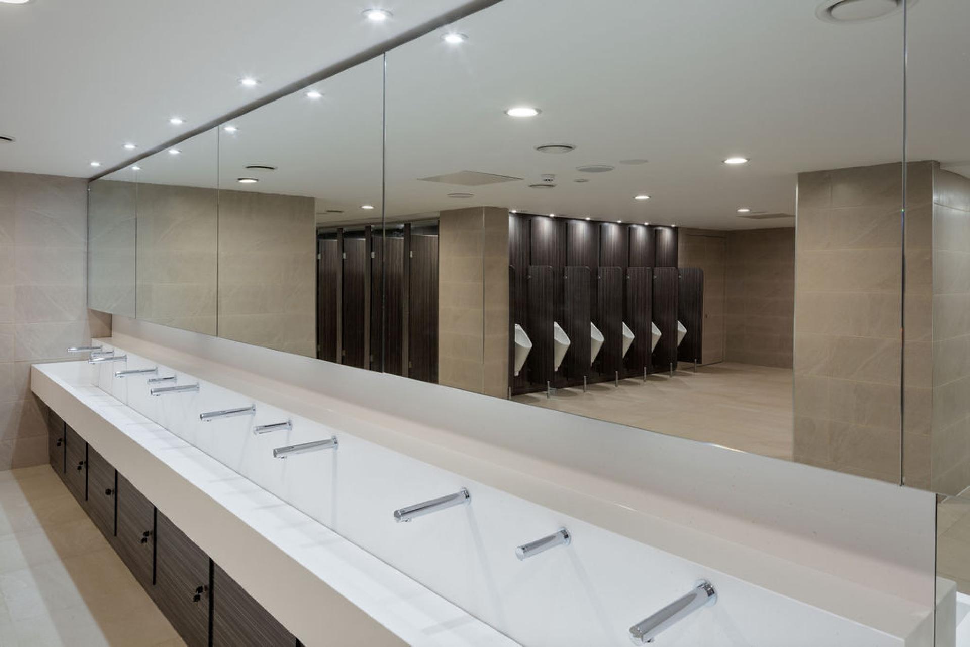 Modern washroom interior at Liverpool Street Station featuring sleek sinks and private stalls, highlighting recent renovations.