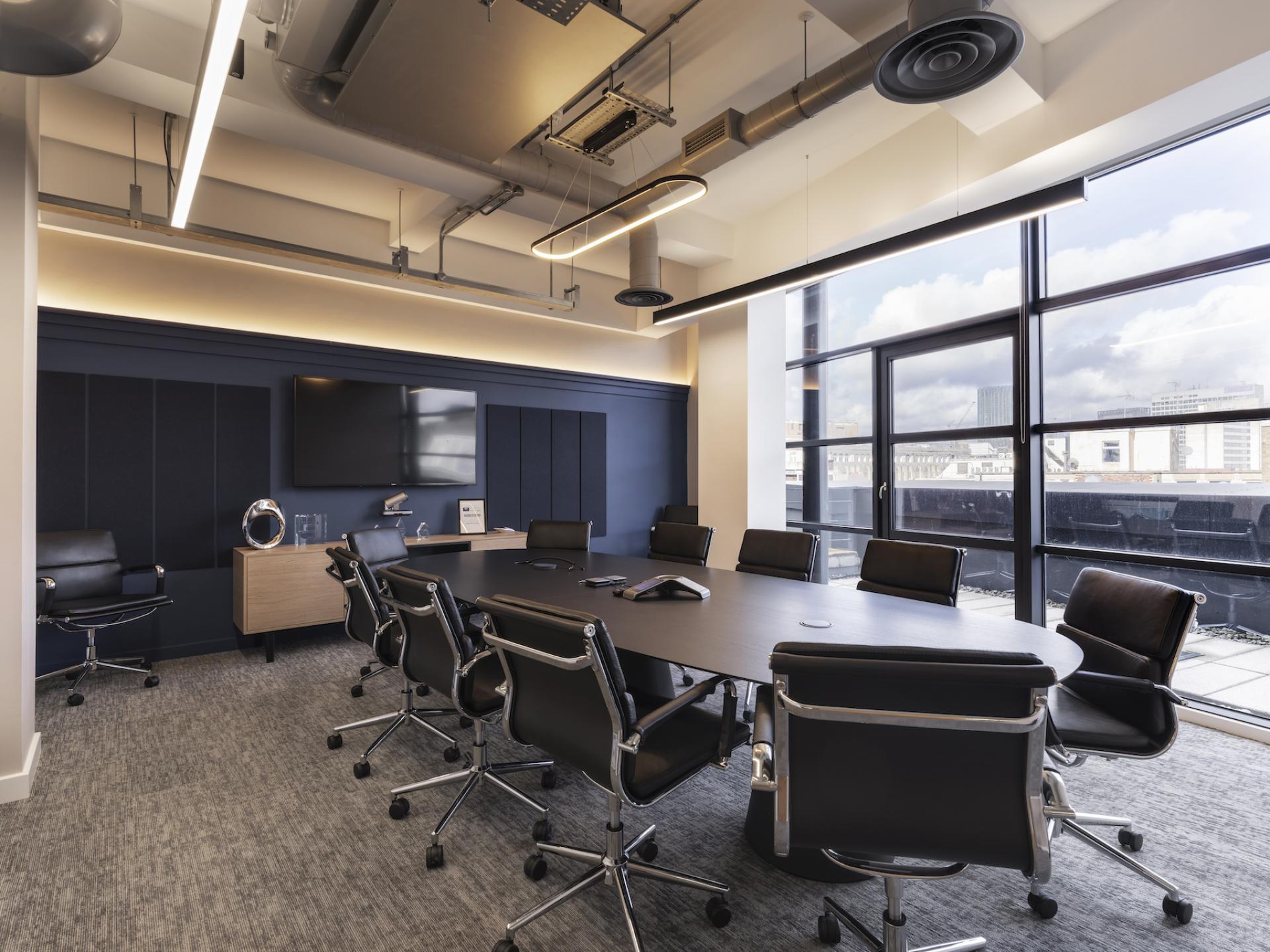 Modern conference room design showcasing sleek furnishings and large windows, highlighting Tosca Debt Capital's innovative Manchester workspace.
