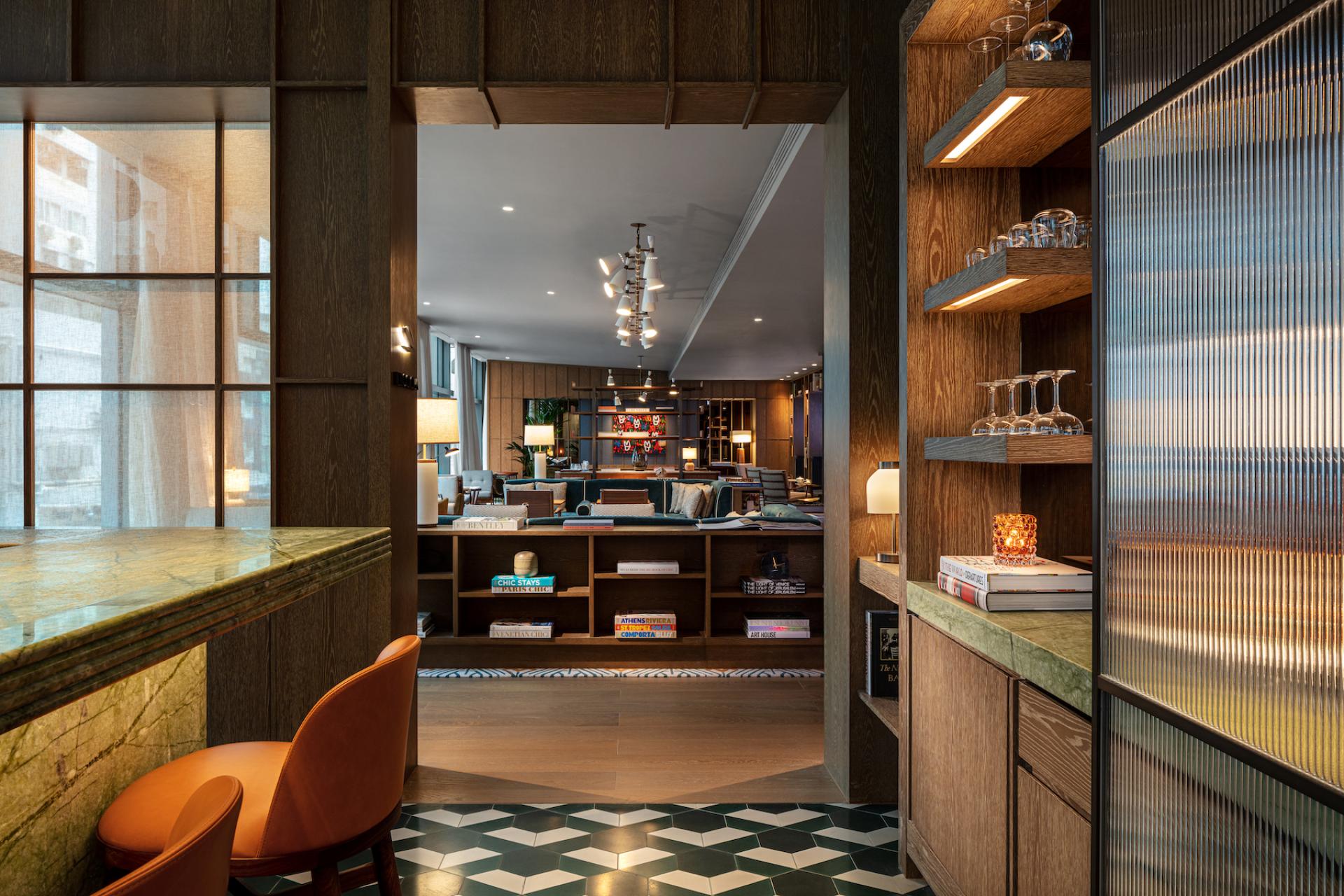 Elegant hotel interior featuring a green stone bar, stylish seating, and modern decor at The Hari, Hong Kong.