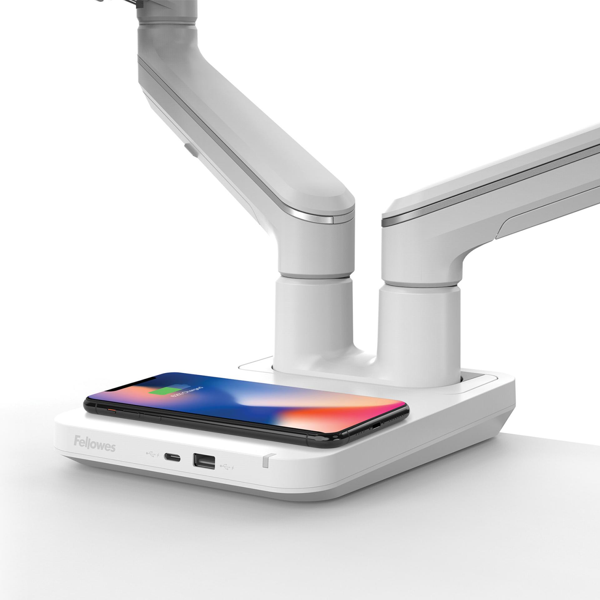 Fellowes Tallo™ monitor arms with a wireless charging pad and integrated USB ports for modern office setups.