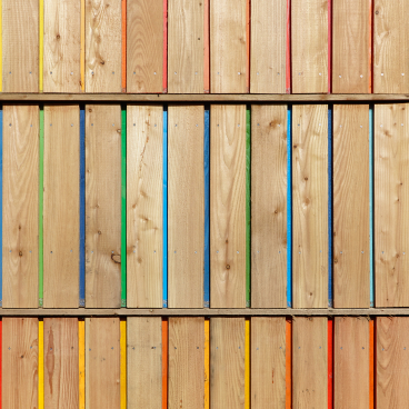 Colorful wooden slats arranged vertically, highlighting diversity in wood design featured in Wood Awards 2021 nominations.