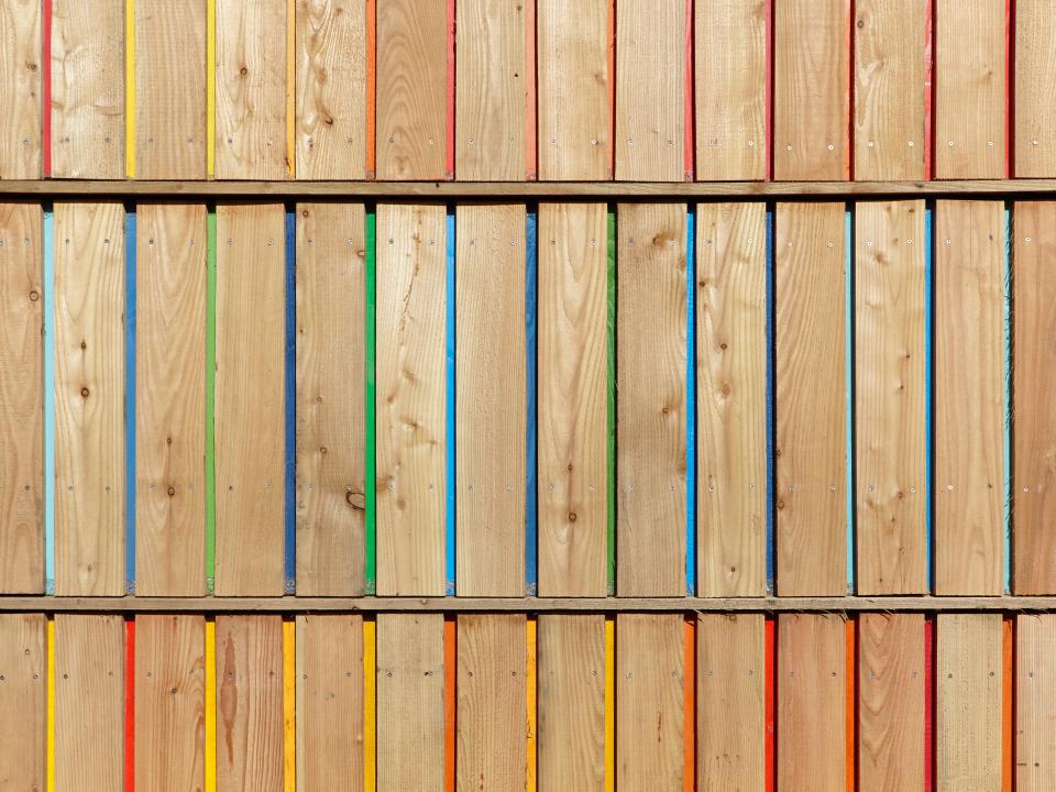 Colorful wooden slats arranged vertically, highlighting diversity in wood design featured in Wood Awards 2021 nominations.