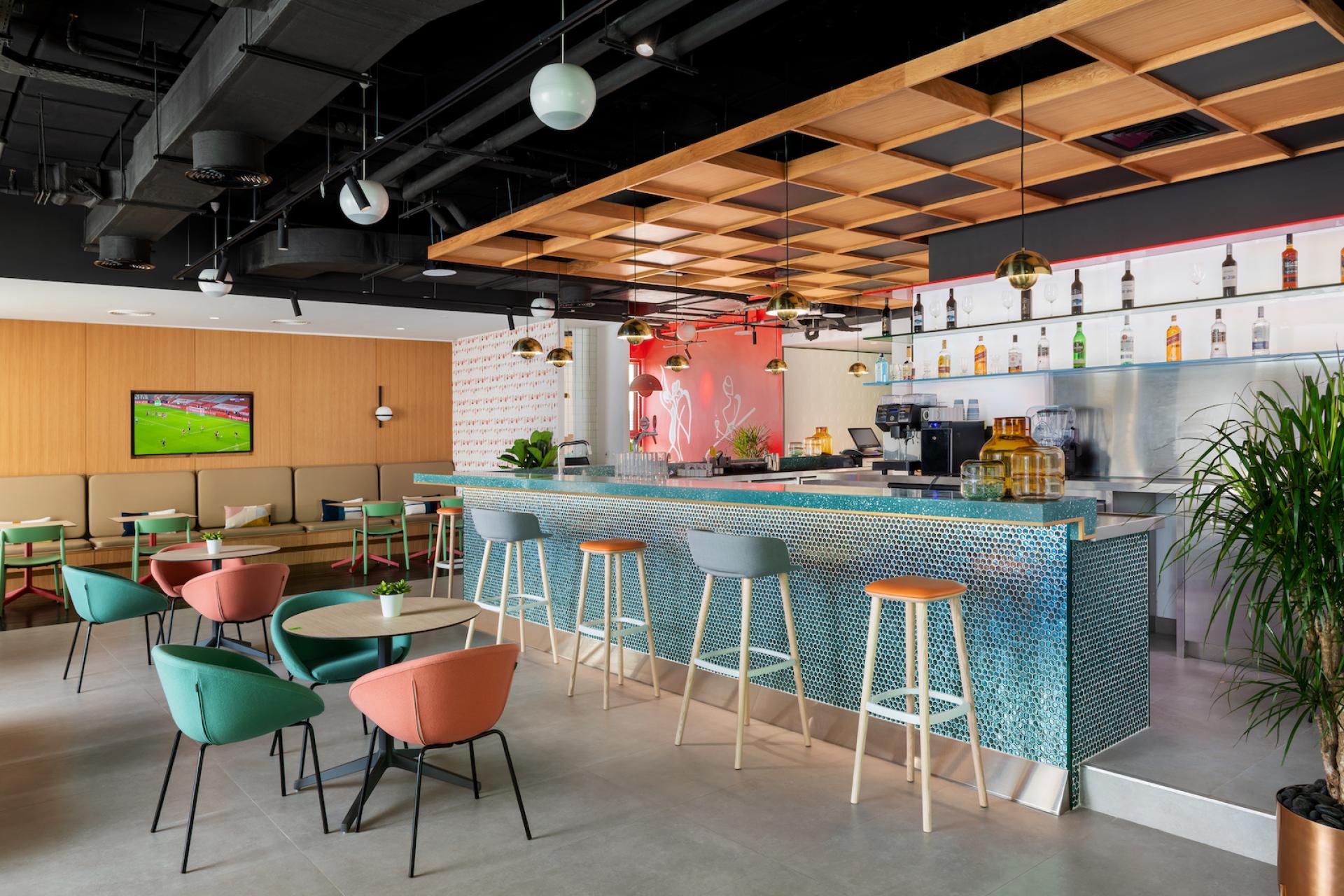 Stylish bar interior featuring modern seating, vibrant colors, and a sophisticated design, showcasing H2R's attention to detail.