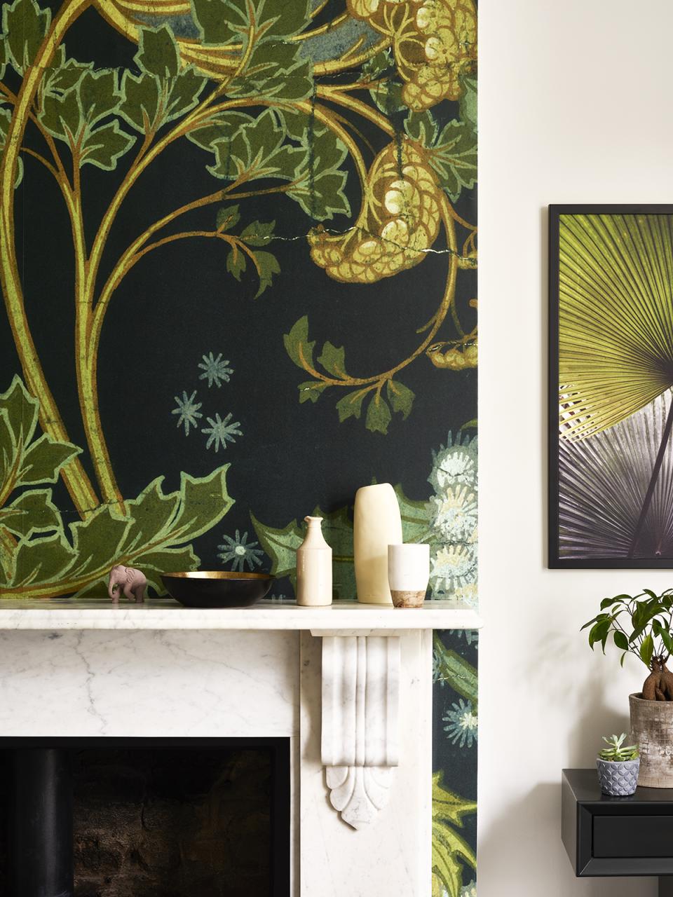 Vibrant botanical mural and decorative elements on a mantelpiece, showcasing a nature-inspired interior design aesthetic.