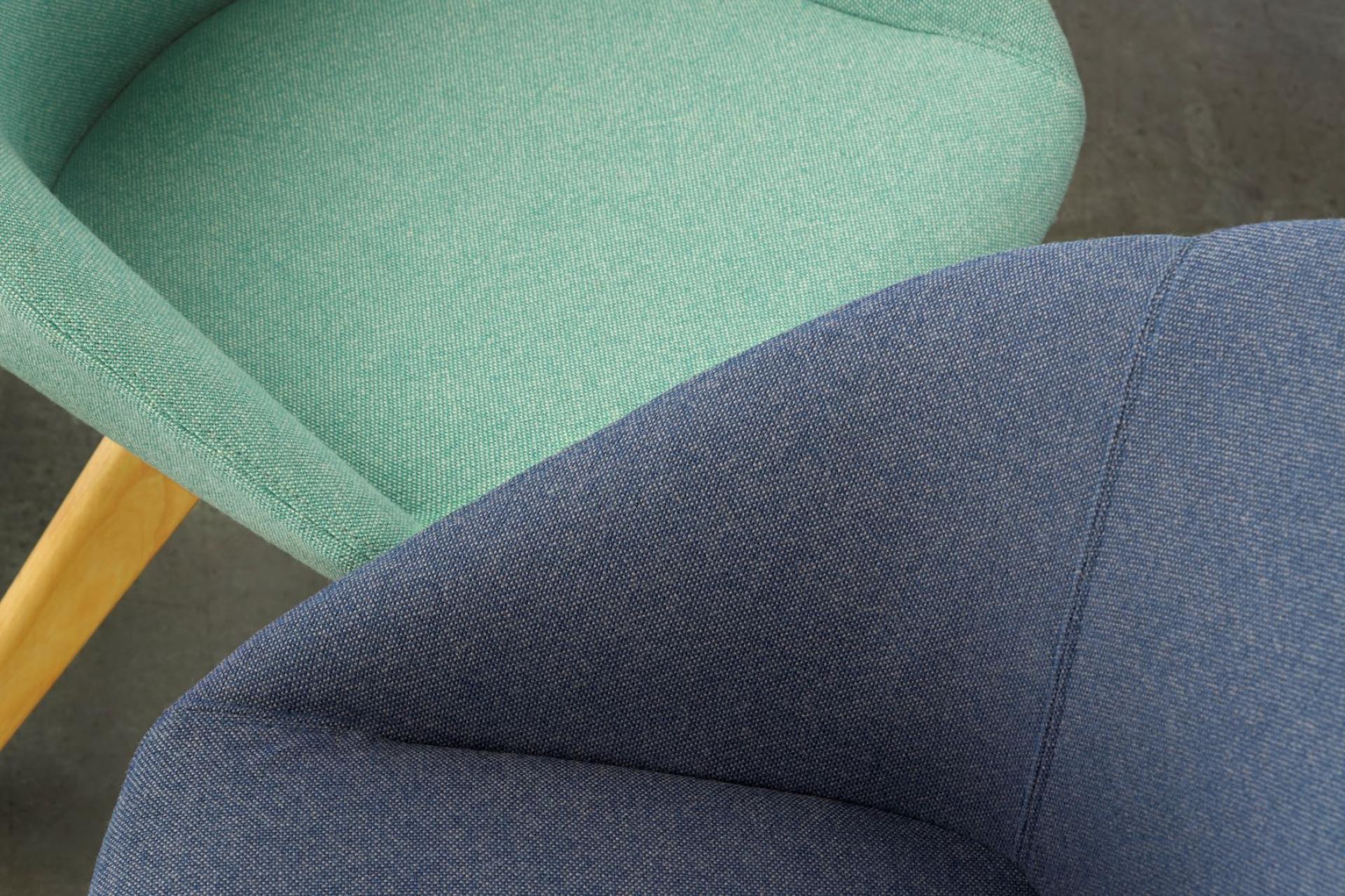 Woven Image's new wool-rich upholstery fabrics in green and blue colors showcased in stylish chair designs.